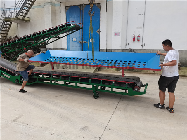 Bulk grain unloading belt conveyor that is loading the hopper on the project site